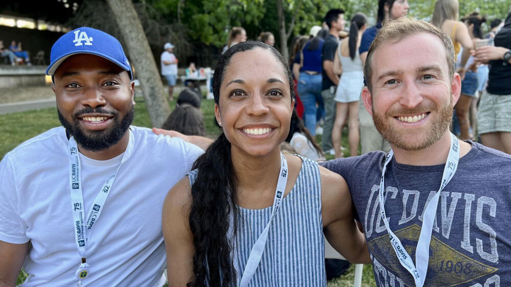 Close-up of three veterinary students at a social function.