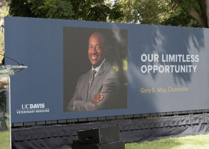 Large signage that says, "Our Limitless Opportunity", next to an image of Chancellor Gary May.